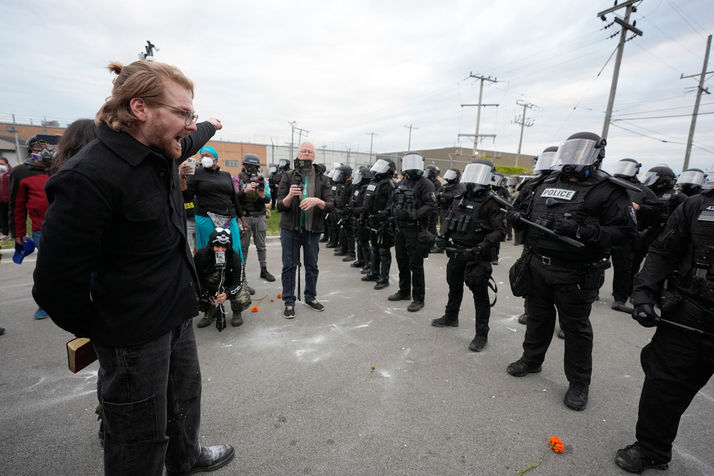 Protesters standoff with law enforcement outside an ICE processing facility in the Chicago suburb of Broadview, Ill., Saturday, Nov. 1, 2025. (AP Photo/Alex Brandon)
