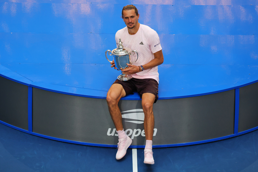 Alexander Zverev, of Germany, holds his trophy after winning the men's singles final of the U.S. Open tennis championships against Ben Shelton, of the United States, Sunday, Sept. 13, 2026, in New York. (AP Photo/Andres Kudacki)