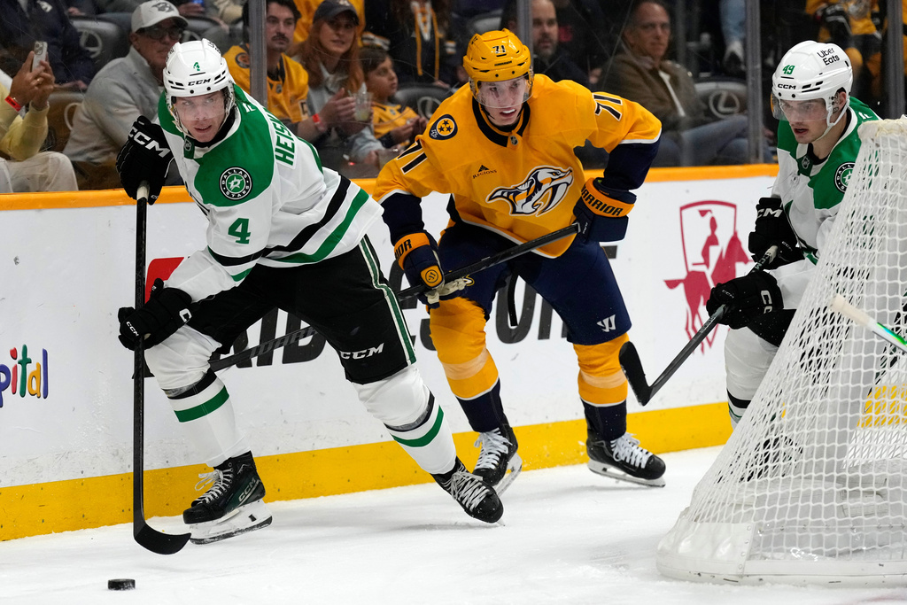 Dallas Stars defenseman Miro Heiskanen (4) clears the puck away from Nashville Predators right wing Matthew Wood (71) during the second period of an NHL hockey game Saturday, Nov. 8, 2025, in Nashville, Tenn. (AP Photo/Mark Humphrey)