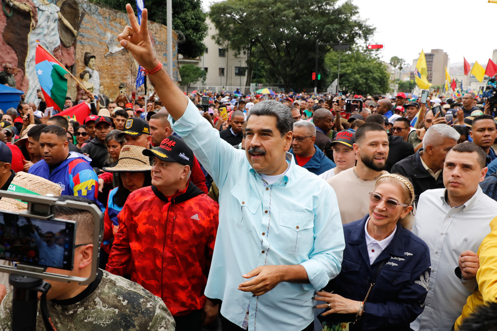 President Nicolas Maduro joins a rally marking the anniversary of the Battle of Santa Ines, which took place during Venezuela's 19th-century Federal War, in Caracas, Venezuela, Wednesday, Dec. 10, 2025. (AP Photo/Cristian Hernandez)