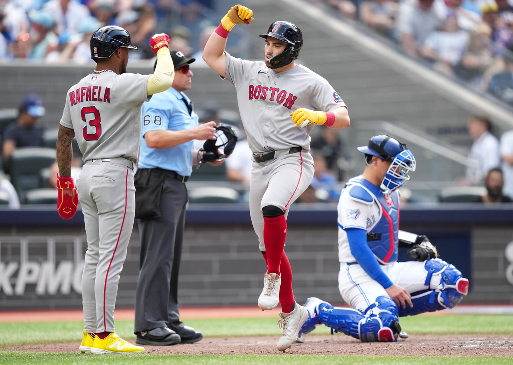 Boston Red Sox third baseman Caleb Durbin (5) celebrates his grand slam with teammate Ceddanne Rafaela (3) as Toronto Blue Jays catcher Brandon Valenzuela (59) looks on during the eighth inning of a baseball game in Toronto, Thursday, Aug. 13, 2026. (Nathan Denette/The Canadian Press via AP)