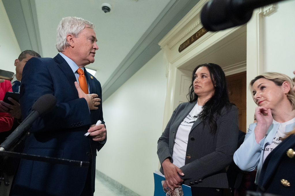 James Comer, R-Ky., the House Oversight and Government Reform Committee Chairman, from left, addresses Sharlene Rochard and Dani Bensky, survivors of Jeffrey Epstein, as he speaks to reporters before the start of the deposition of former Attorney General Pam Bondi at the Rayburn House Office Building on Capitol Hill, Friday, May 29, 2026, in Washington. (AP Photo/Manuel Ceneta)