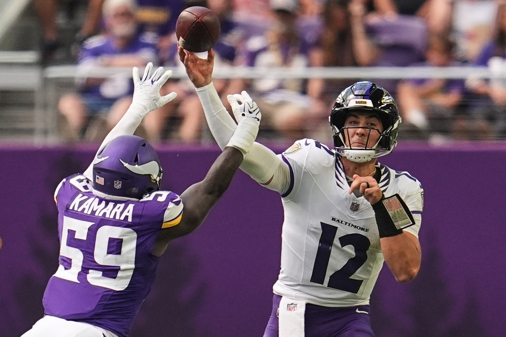 Baltimore Ravens quarterback Joe Fagnano (12) throws against Minnesota Vikings linebacker Bangally Kamara (59) during the second half of an NFL preseason football game, Saturday, Aug. 22, 2026, in Minneapolis. (AP Photo/Abbie Parr)