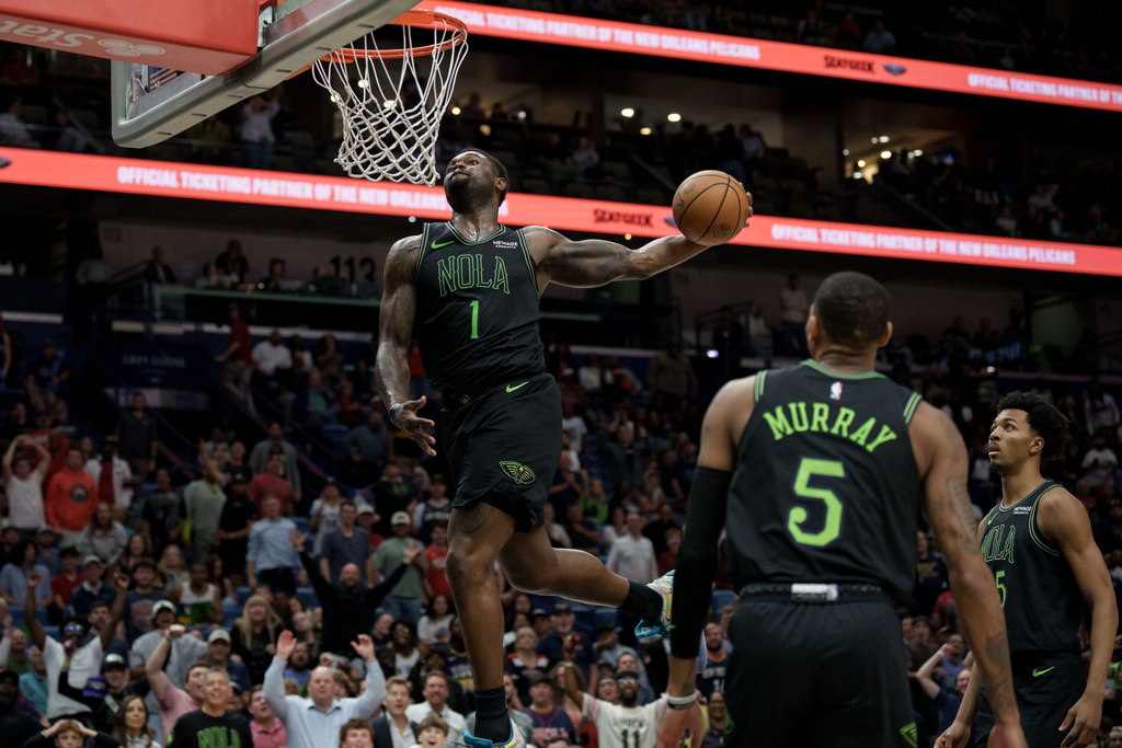 New Orleans Pelicans forward Zion Williamson (1) does a windmill dunk against the Toronto Raptors during the second half of an NBA basketball game in New Orleans, Wednesday, March 11, 2026. (AP Photo/Matthew Hinton)