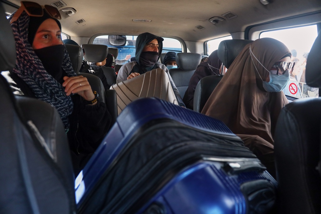 Family members of suspected Islamic State militants who are Australian nationals sit in a van heading to the airport in Damascus during the first repatriation operation of the year, at Roj Camp in eastern Syria, Monday, Feb. 16, 2026. Thirty-four Australian citizens from 11 families departed the camp. (AP Photo/Baderkhan Ahmad)