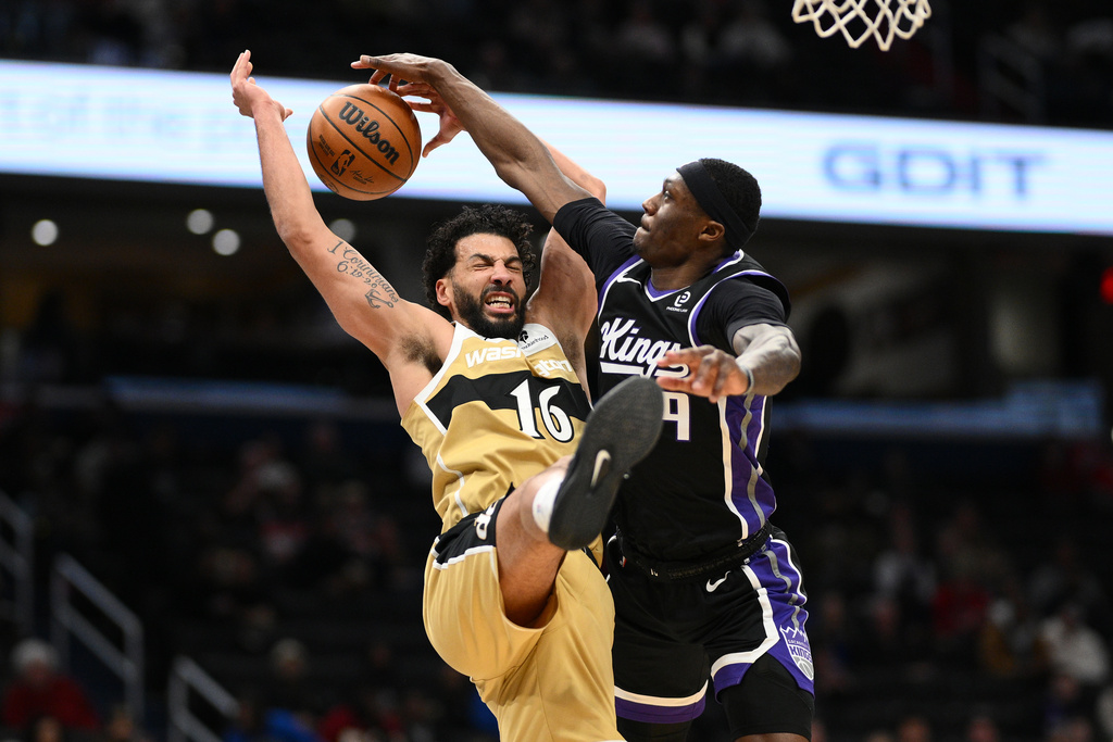 Sacramento Kings guard Daeqwon Plowden, right, blocks Washington Wizards forward Anthony Gill (16) during the first half of an NBA basketball game, Sunday, Feb. 1, 2026, in Washington. (AP Photo/Nick Wass)