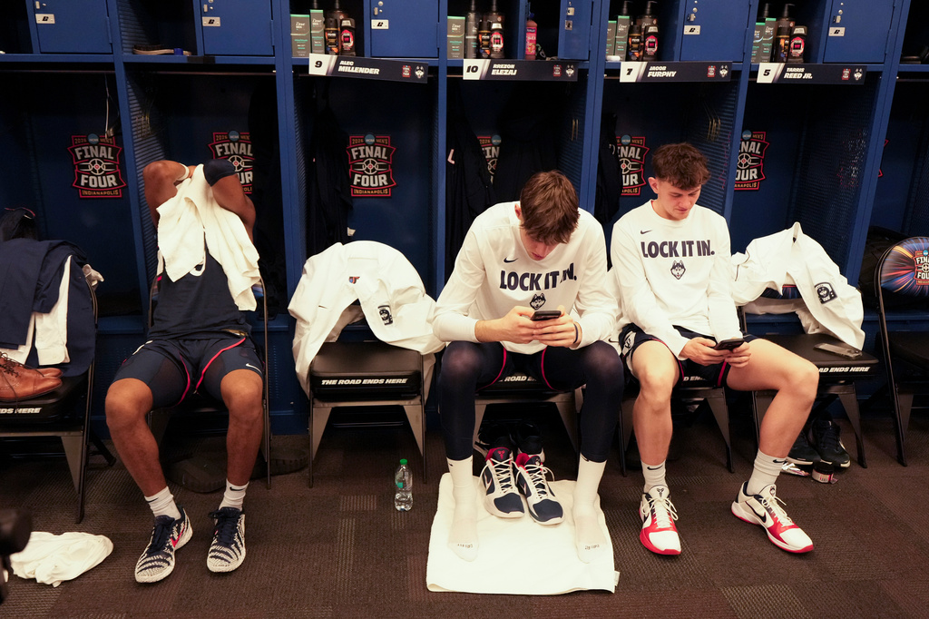 UConn players sit in their locker room after losing to Michigan in the NCAA college basketball tournament national championship game at the Final Four, Monday, April 6, 2026, in Indianapolis. (AP Photo/AJ Mast)