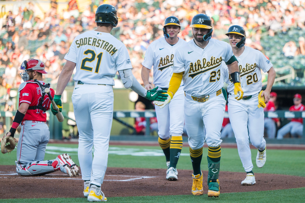 Athletics' Shea Langeliers (23) celebrates with Tyler Soderstrom (21) after hitting a home run during the first inning of a baseball game against the Los Angeles Angels in West Sacramento, Calif., Thursday, June 18, 2026. (AP Photo/Nic Coury)