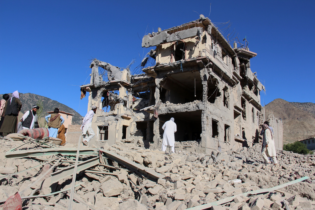Residents walk through the rubble after what Taliban officials said were Pakistani airstrikes a day earlier that killed civilians, including children, in the village of Mandokhail, Chamkani district, Paktia province, Afghanistan, Monday, June 29, 2026. (AP Photo/Saifullah Zahir)