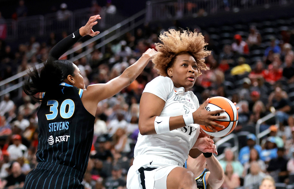 Las Vegas Aces forward NaLyssa Smith, right, makes a rebound in front of Chicago Sky forward-center Azura Stevens (30) during the first half of an WNBA basketball game Friday, July 3, 2026, in Las Vegas. (Steve Marcus/Las Vegas Sun via AP)
