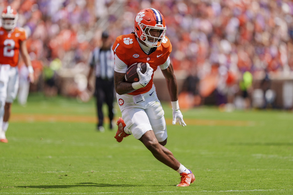 Clemson wide receiver T.J. Moore (1) runs with the ball in the first half of an NCAA college football game against Syracuse, Saturday, Sept. 20, 2025, in Clemson, S.C. (AP Photo/Jacob Kupferman)