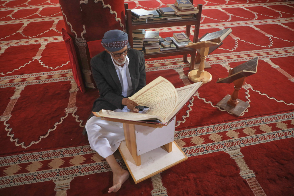 A worshipper reads from an oversized Quran at the Al-Shamy Mosque in Houthi-controlled Sanaa, Yemen, Friday, Sept. 11, 2026. (AP Photo/Osamah Abdulrahman)