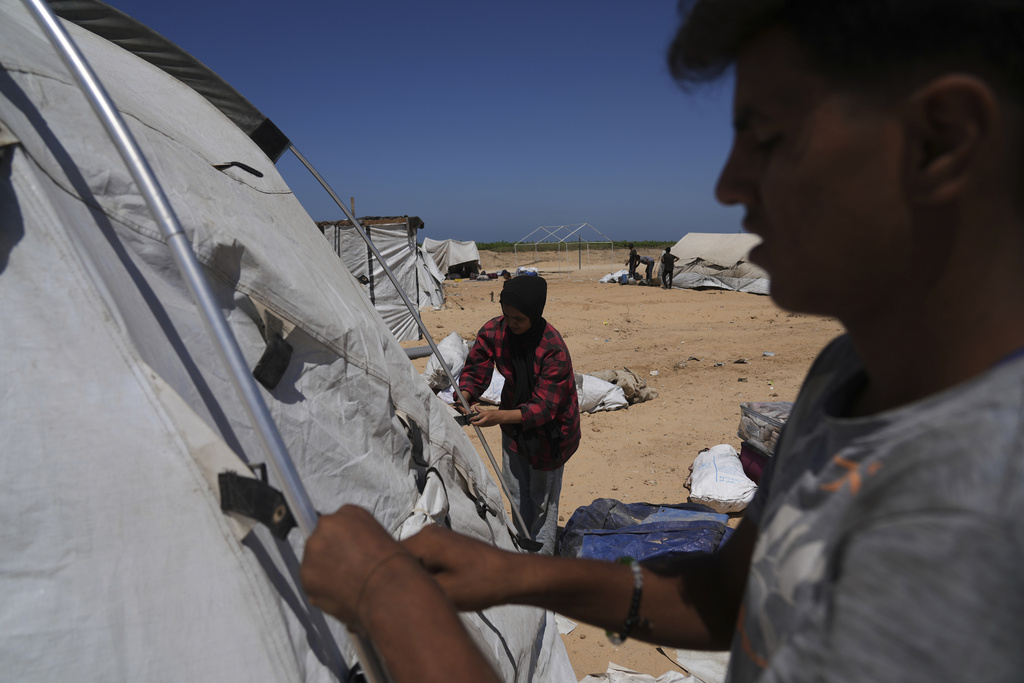 Members of the Abu Jarad family set up their tent in Khan Younis, Gaza Strip, following their displacement from Gaza City, Sept. 11, 2025. (AP Photo/Abdel Kareem Hana)