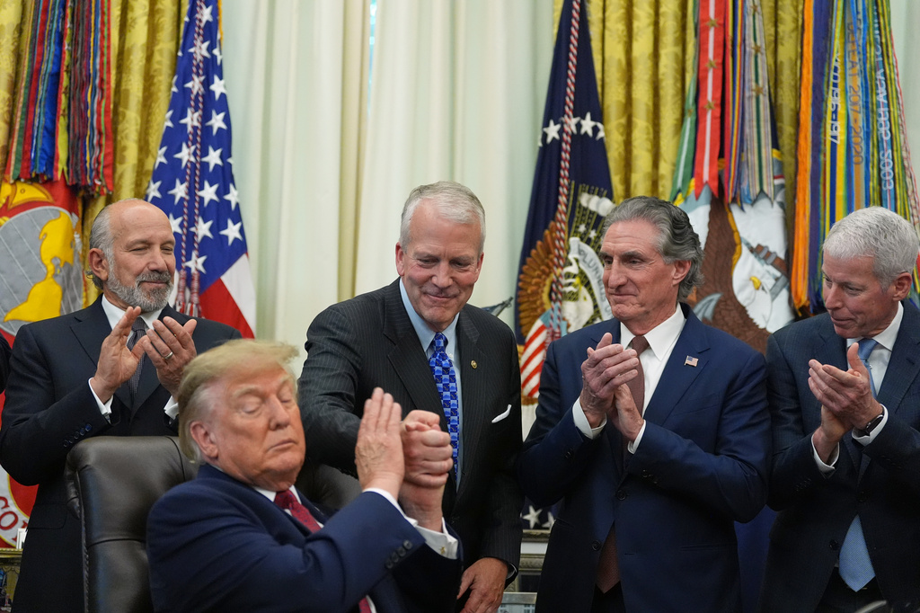 President Donald Trump shakes hands with Sen. Dan Sullivan, R-Alaska, as he speaks in the Oval Office of the White House, Wednesday, Sept. 30, 2026, in Washington, as Commerce Secretary Howard Lutnick, Interior Secretary Doug Burgum and Energy Secretary Chris Wright applaud. (AP Photo/Alex Brandon)