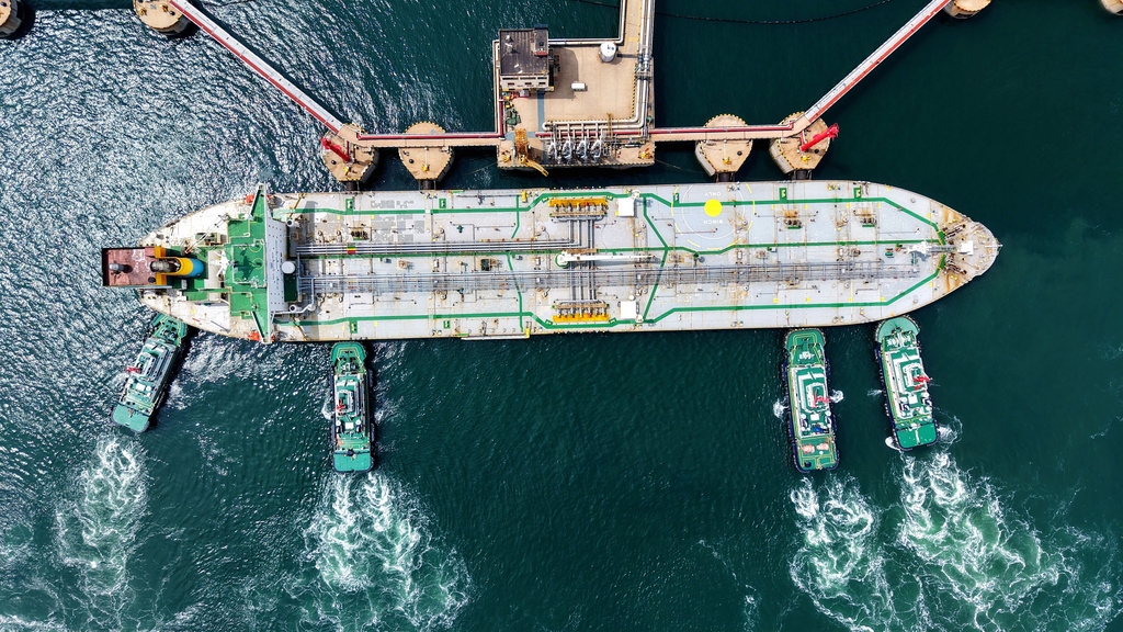 Tugboats push a crude oil tanker into position at a pier handling oil imports in Qingdao in eastern China's Shandong province, Saturday, April 11, 2026. (Chinatopix Via AP) CHINA OUT