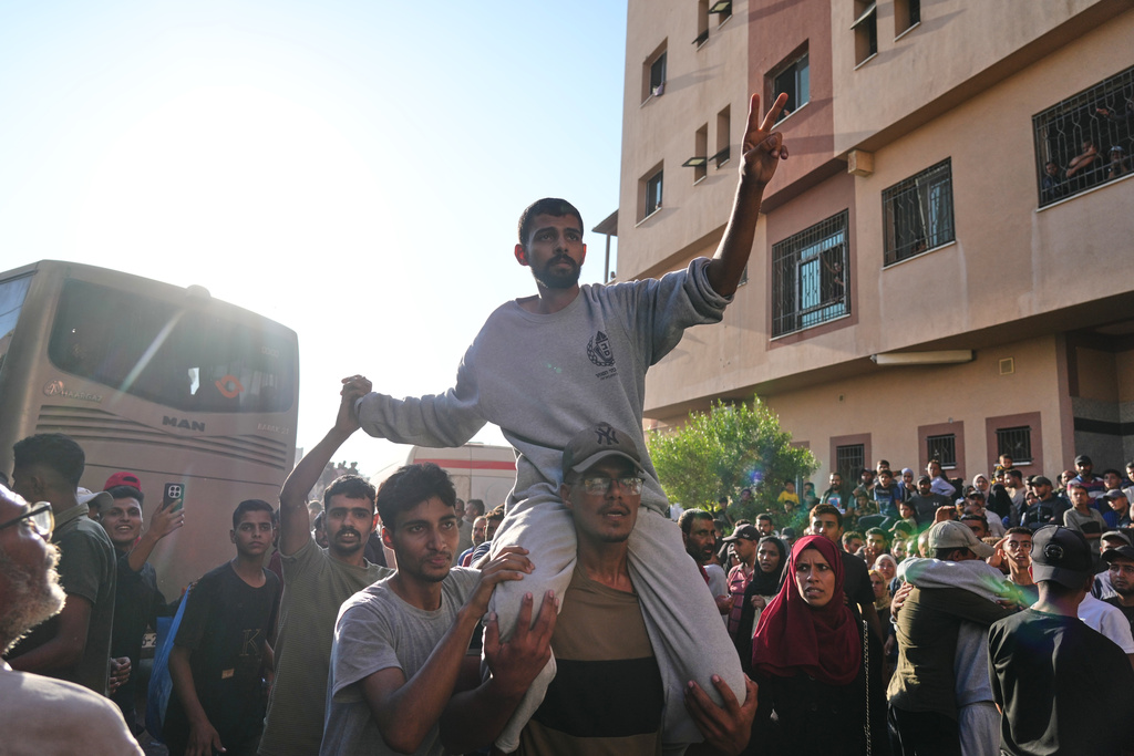 A freed Palestinian prisoner is greeted by a crowd as he arrives in the Gaza Strip after his release from Israeli jails under a ceasefire agreement between Hamas and Israel, in Khan Younis, southern Gaza Strip, Monday, Oct. 13, 2025. (AP Photo/Jehad Alshrafi)