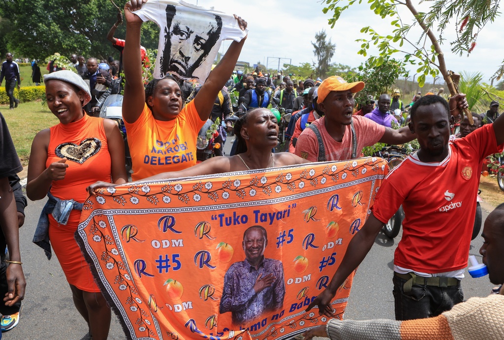 Supporters of Kenya's former Prime Minister Raila Odinga escort his body after arriving in Nairobi, Kenya, Thursday, Oct. 16, 2025. Odinga died Wednesday in India at the age of 80. (AP Photo/Andrew Kasuku)