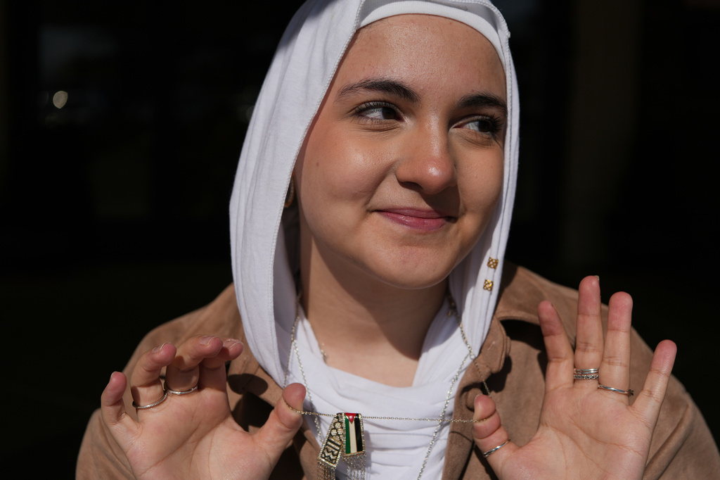 Haneen Alatiyat, a member of the Islamic Center of Passaic County in Paterson, N.J., poses for a portrait at the mosque's entrance during Ramadan on Friday, Feb. 27, 2026. (AP Photo/Luis Andres Henao)