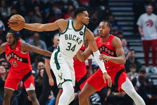 Milwaukee Bucks' Giannis Antetokounmpo (34) looks for options with pressure from Toronto Raptors' Scottie Barnes (4) during first half NBA basketball action in Toronto on Friday, Oct. 24, 2025. (Nick Iwanyshyn/The Canadian Press via AP) Milwaukee Bucks' Giannis Antetokounmpo (34) looks for options with pressure from Toronto Raptors' Scottie Barnes (4) during first half NBA basketball action in Toronto on Friday, Oct. 24, 2025. (Nick Iwanyshyn/The Canadian Press via AP)