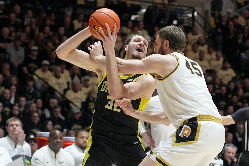 Oregon center Nate Bittle (32) is fouled by Purdue center Oscar Cluff (45) during the first half of an NCAA college basketball game in West Lafayette, Ind., Saturday, Feb. 7, 2026. (AP Photo/AJ Mast)