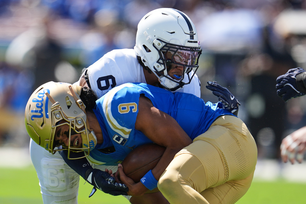 UCLA quarterback Nico Iamaleava (9) is tackled by Penn State safety Zakee Wheatley (6) during the first half of an NCAA college football game against Penn State, Saturday, Oct. 4, 2025, in Pasadena, Calif. (AP Photo/Marcio Jose Sanchez)