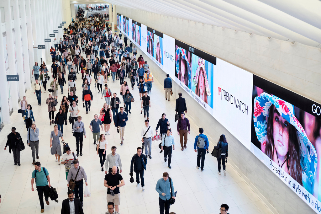 FILE - Commuters walk through a corridor in the World Trade Center Transportation Hub in New York on June 21, 2019. (AP Photo/Mark Lennihan, File)