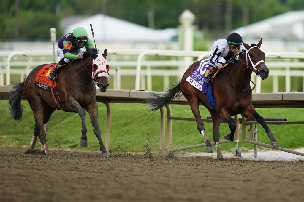 Tyler Gaffalione, right, atop My Miss Mo, edges out Luis Saez, atop Jumping the Gun, to take the lead during the 102nd running of the Black-Eyed Susan horse race, Friday, May 15, 2026, at Laurel Park in Laurel, Md. (AP Photo/Stephanie Scarbrough)