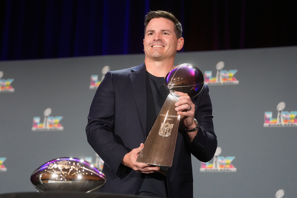 Seattle Seahawks head coach Mike MacDonald holds the Lombardi Trophy while posing during a news conference the morning after Super Bowl 60 between the Seahawks and the New England Patriots in San Francisco, Monday, Feb. 9, 2026. (AP Photo/Jeff Chiu)