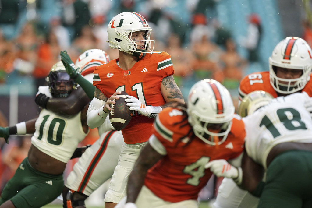 Miami quarterback Carson Beck looks for an opening to pass during the first half of an NCAA college football game against South Florida, Saturday, Sept. 13, 2025, in Miami Gardens, Fla. (AP Photo/Rebecca Blackwell)