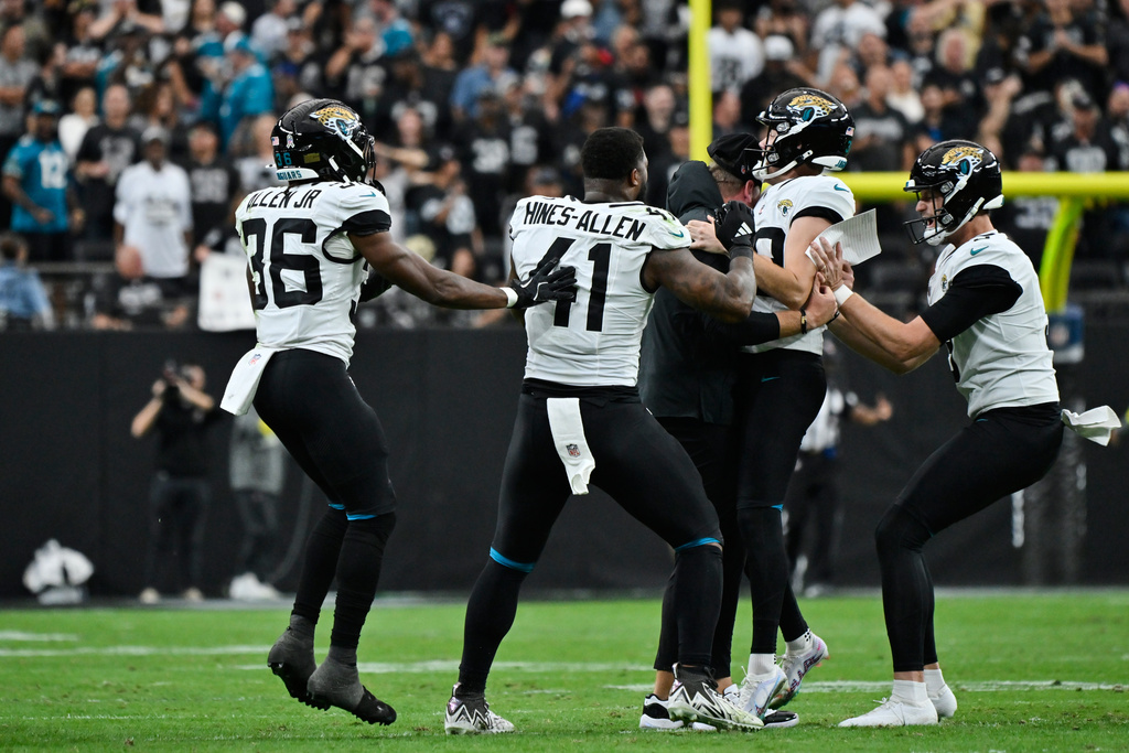 Jacksonville Jaguars place kicker Cam Little, second from right, is congratulated by head coach Liam Coen, center, and teammates after making a 68-yard field goal during the first half of an NFL football game against the Las Vegas Raiders, Sunday, Nov. 2, 2025, in Las Vegas. (AP Photo/David Becker)