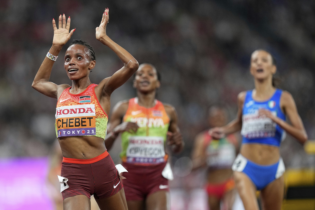 Kenya's Beatrice Chebet celebrates as she wins the gold medal in the women's 5,000 meters final at the World Athletics Championships in Tokyo, Saturday, Sept. 20, 2025. (AP Photo/Petr David Josek)