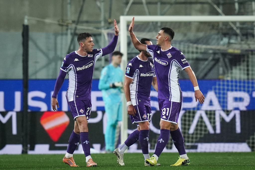 Fiorentina's Robin Everardus Gosens , left, celebrates with teammate Roberto Piccoli after scoring their side's first goal of the game during the Serie A soccer match between Fiorentina and Lazio in Florence, Italy, Monday, April 13, 2026. (Massimo Paolone/LaPresse via AP)