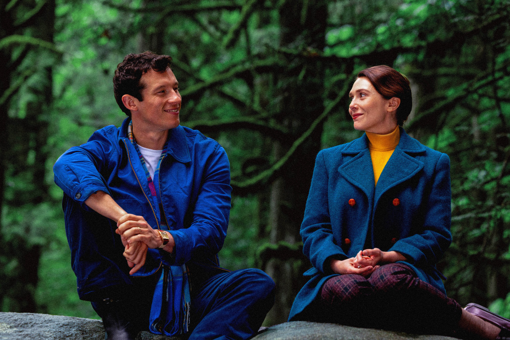 This image released by A24 shows Callum Turner, left, and Elizabeth Olsen in a scene from "Eternity." (A24 via AP)