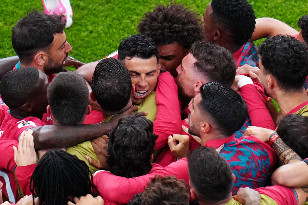 Portugal's Cristiano Ronaldo, center, celebrates with teammates after scoring the opening goal during the World Cup Group K soccer match between Portugal and Uzbekistan in Houston, Tuesday, June 23, 2026. (AP Photo/Karen Warren)