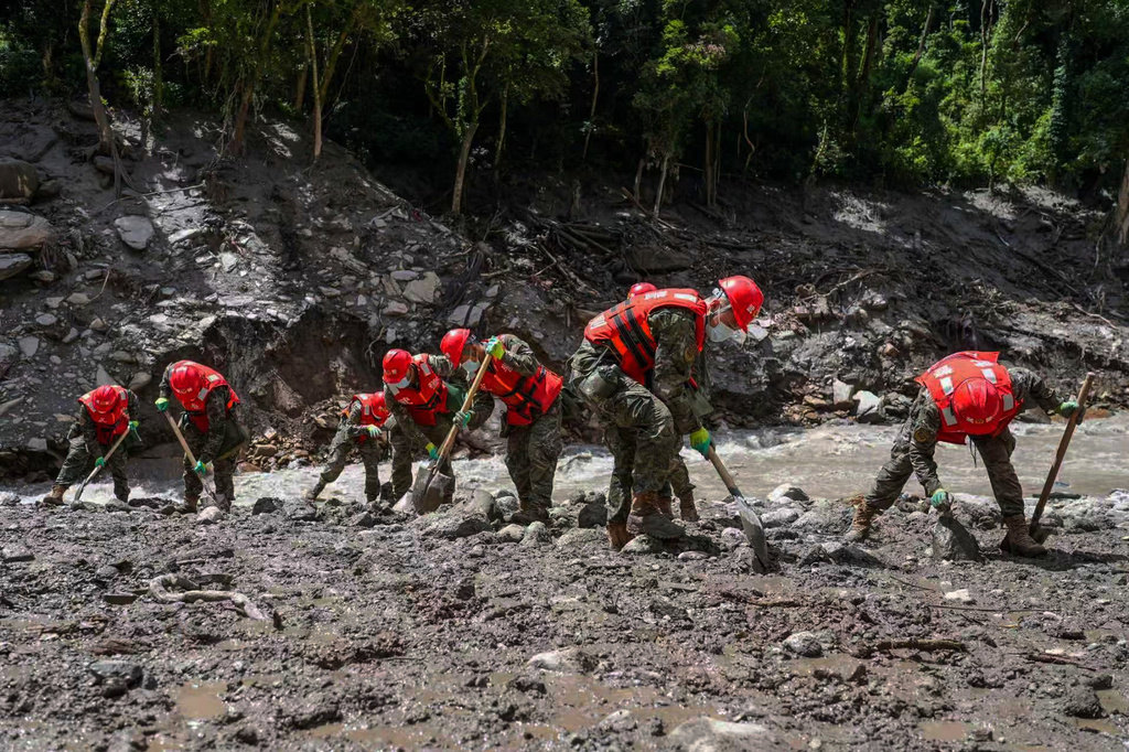 In this photo released by Xinhua News Agency, rescuers from the People's Armed Police Force search for victims at the mudslide-hit area near Gyirong Port in Gyirong County, in Xigaze, southwest China's Tibet Autonomous Region on Friday, Aug. 28, 2026. (Liu Shuang/Xinhua via AP)