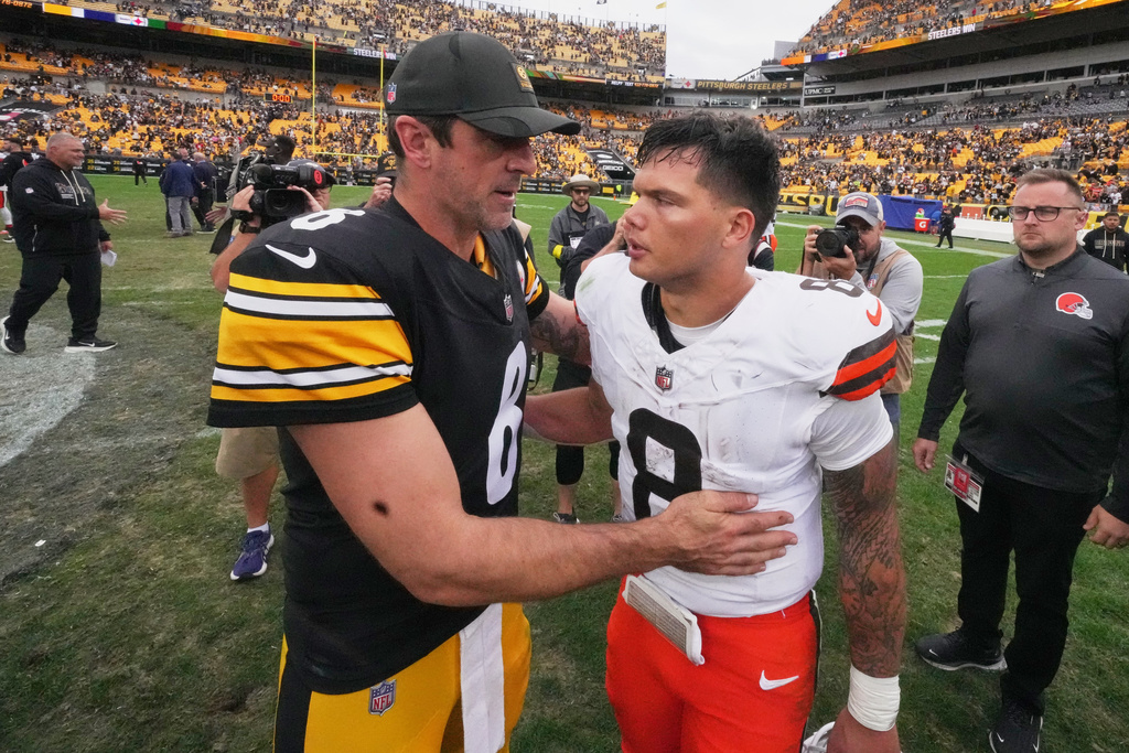 Pittsburgh Steelers quarterback Aaron Rodgers, left, and Cleveland Browns quarterback Dillon Gabriel, right, greet each other after their NFL football game in Pittsburgh, Sunday, Oct. 12, 2025. (AP Photo/Gene J. Puskar)