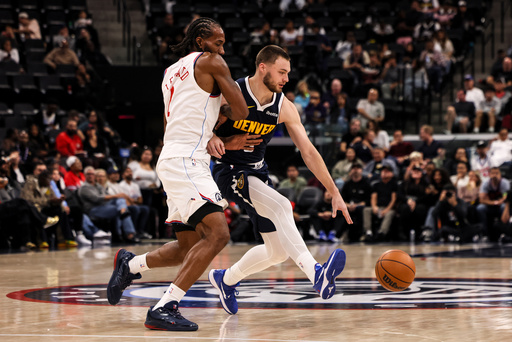 Denver Nuggets guard Christian Braun, right, dribbles past Los Angeles Clippers forward Kawhi Leonard during the first half of a preseason NBA basketball game, Sunday, Oct. 12, 2025, in Inglewood, Calif. (AP Photo/Etienne Laurent) Denver Nuggets guard Christian Braun, right, dribbles past Los Angeles Clippers forward Kawhi Leonard during the first half of a preseason NBA basketball game, Sunday, Oct. 12, 2025, in Inglewood, Calif. (AP Photo/Etienne Laurent)