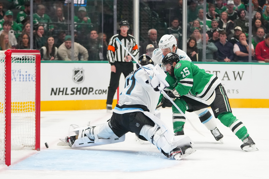 Dallas Stars center Colin Blackwell (15) attacks on the net of Utah Mammoth goaltender Vitek Vanecek during the first period of an NHL hockey game Monday, March 16, 2026, in Dallas. (AP Photo/Julio Cortez)