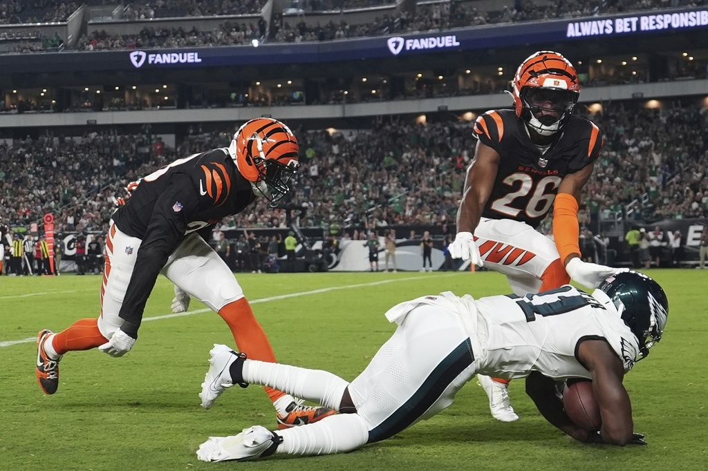 Philadelphia Eagles wide receiver Darius Cooper (41) scores a touchdown in front of Cincinnati Bengals safety Tycen Anderson (26) during the first half of an NFL preseason football game Thursday, Aug. 7, 2025, in Philadelphia. (AP Photo/Matt Slocum)