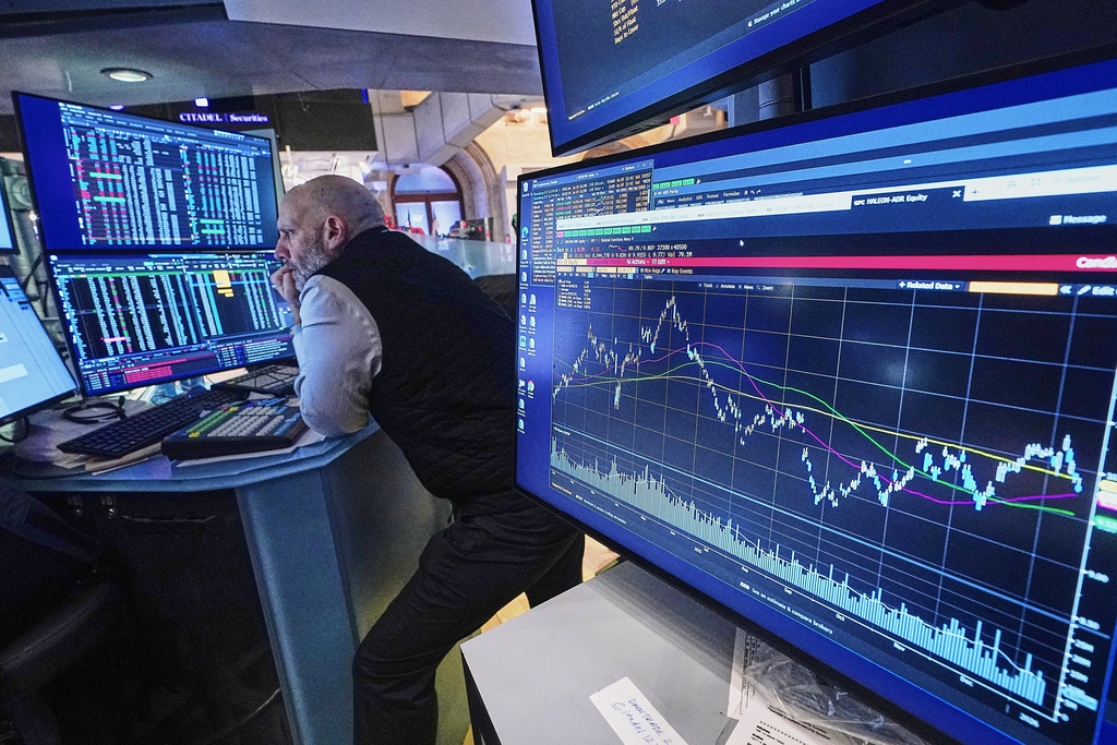 Specialist Meric Greenbaum works at his post on the floor of the New York Stock Exchange, Monday, Jan. 12, 2026. (AP Photo/Richard Drew)