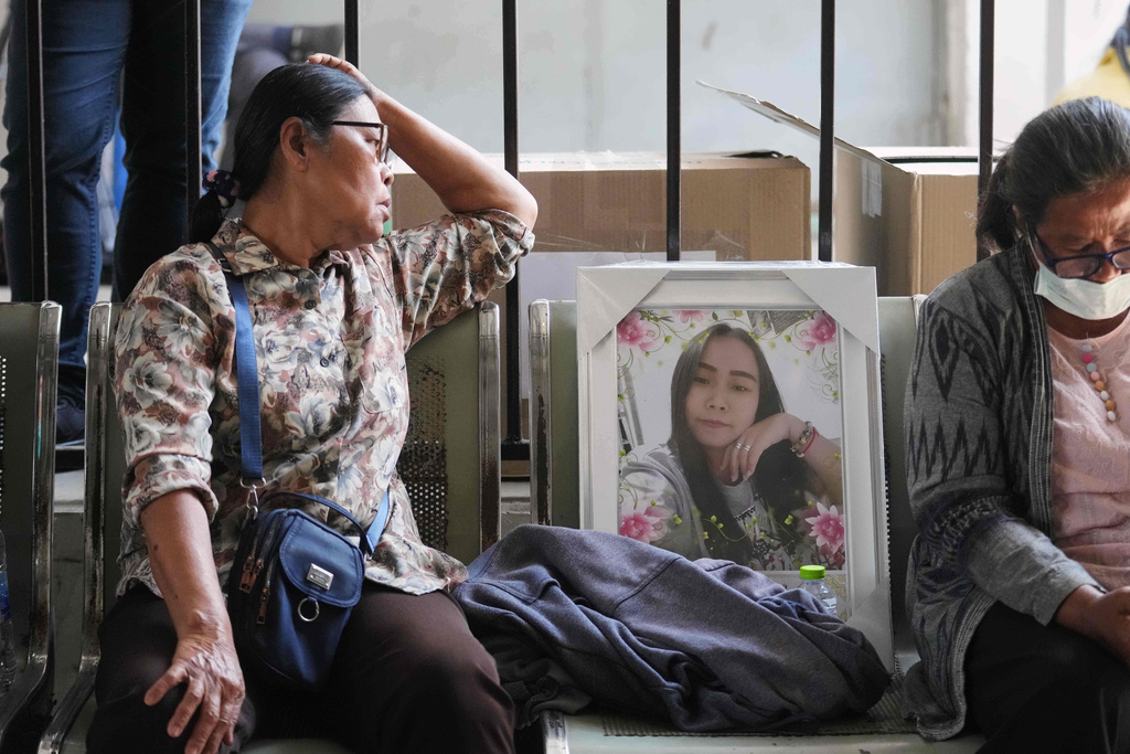 Relatives wait at a hospital to receive bodies of victims, a day after a construction crane fell into a passenger train in Nakhon Ratchasima province, Thailand, Thursday, Jan.15, 2026. (AP Photo/Sakchai Lalit)