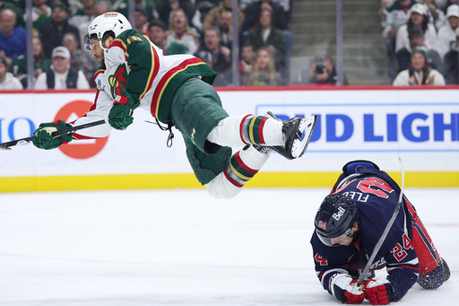 Minnesota Wild center Vinnie Hinostroza, left, dives after a shot as Winnipeg Jets defenseman Haydn Fleury (24) defends during the first period of an NHL hockey game Tuesday, Oct. 28, 2025, in St. Paul, Minn. (AP Photo/Matt Krohn) Minnesota Wild center Vinnie Hinostroza, left, dives after a shot as Winnipeg Jets defenseman Haydn Fleury (24) defends during the first period of an NHL hockey game Tuesday, Oct. 28, 2025, in St. Paul, Minn. (AP Photo/Matt Krohn)