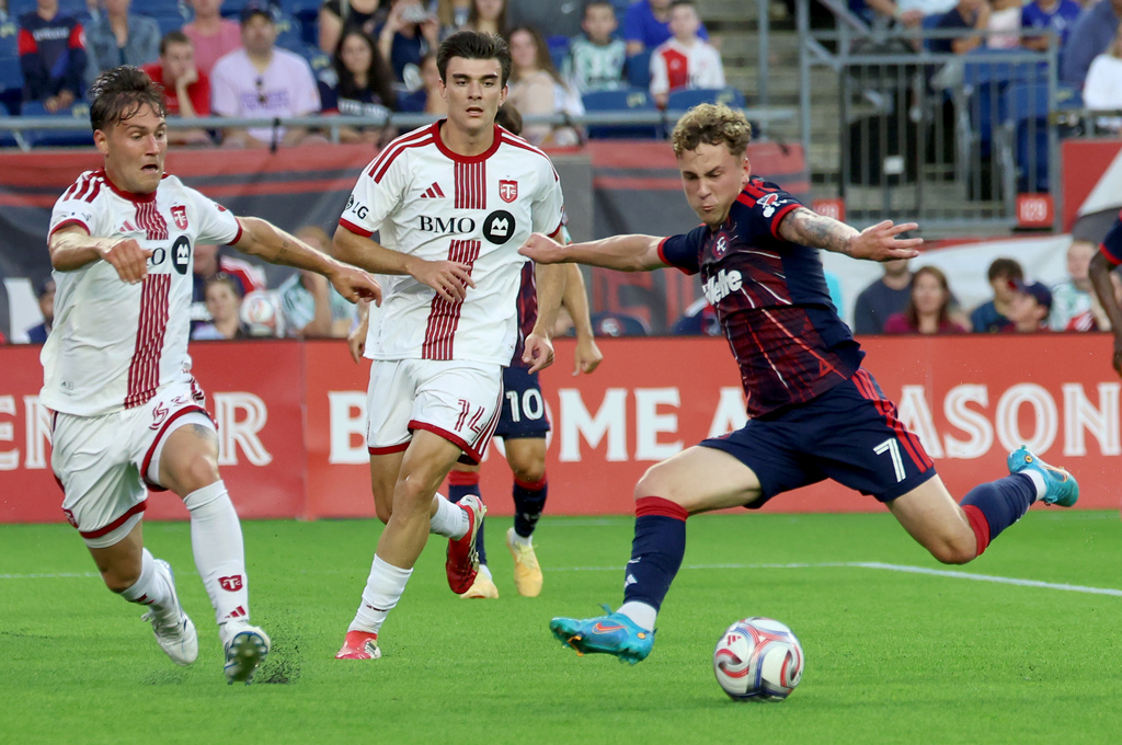 New England Revolution's Griffin Yow (7) attempts to score next to Toronto FC's Jackson Gilman (38) and Alonso Coello (14) in the first half of an MLS soccer match Wednesday, July 22, 2026, in Foxborough, Mass. (AP Photo/Mark Stockwell)