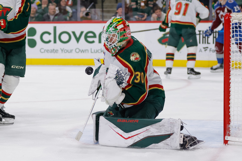 Minnesota Wild goaltender Jesper Wallstedt (30) makes a save during the second period of an NHL hockey game against the Colorado Avalanche, Sunday, Dec. 21, 2025, in St. Paul, Minn. (AP Photo/Bailey Hillesheim)