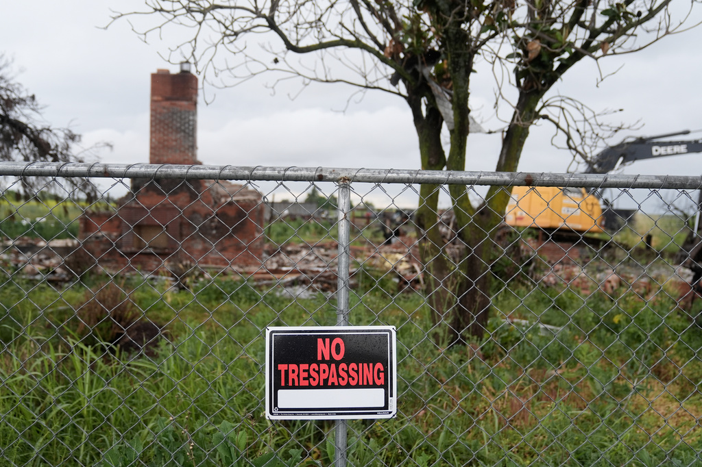 A No Trespassing sign hangs on a fence outside the location of a July 1, 2025, fireworks explosion in Esparto, Calif., Friday, April 10, 2026. (AP Photo/Jeff Chiu)