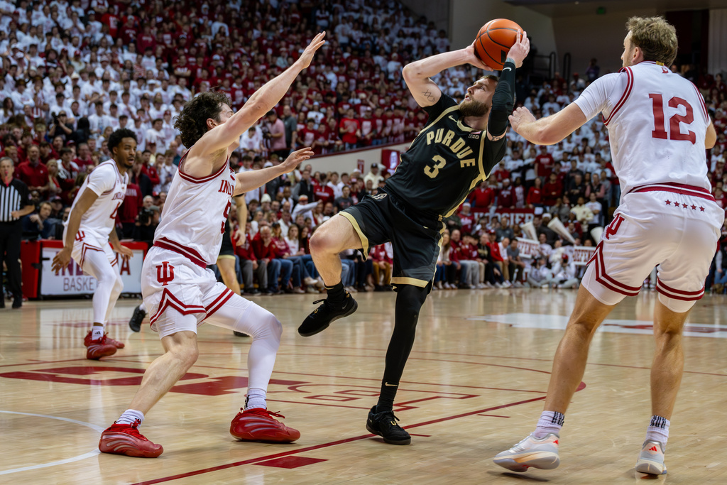 Purdue guard Braden Smith (3) shoots while being defended by Indiana guard Conor Enright and forward Tucker Devries (12) during the first half of an NCAA college basketball game, Tuesday, Jan. 27, 2026, in Bloomington, Ind. (AP Photo/Doug McSchooler)