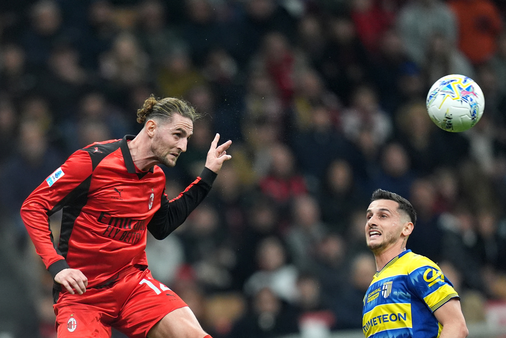 AC Milan's Adrien Rabiot, left, fights for the bass with Parma's Emanuele Valeri during the Italian Serie A soccer match between AC Milan and Parma in Milan, Italy, Sunday, Feb. 22 , 2025. (Spada/LaPresse via AP)