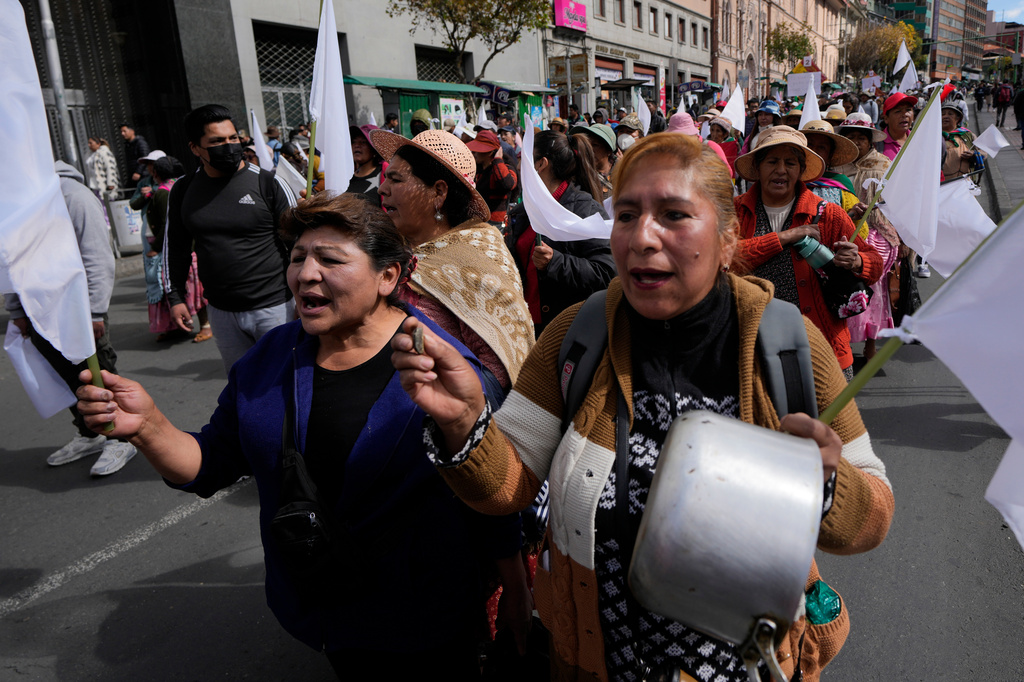 Vendors shout slogans during a march against protesters who are blocking access to the city, in La Paz, Bolivia, Tuesday, May 26, 2026. (AP Photo/Juan Karita)