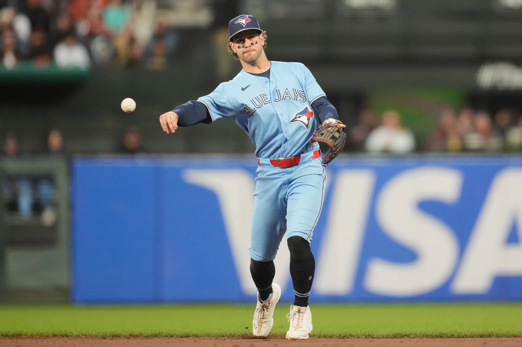 Toronto Blue Jays second baseman Ernie Clement throws out San Francisco Giants' Victor Bericoto at first base during the sixth inning of a baseball game Tuesday, July 7, 2026, in San Francisco. (AP Photo/Jeff Chiu)