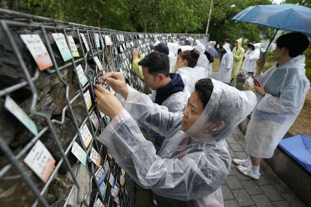 Korean adoptees put their nametags with South Korean volunteers on The Wall of Names at Omma Poom Park in Paju, South Korea, on May 20, 2026. (AP Photo/Ahn Young-joon)
